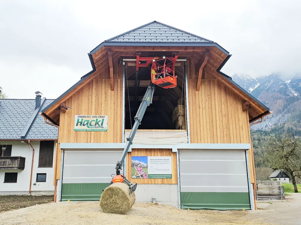 Spezialanfertigung von AGROTEL: Tor für Heukran im Giebelbereich eines modernen Milchviehstalls